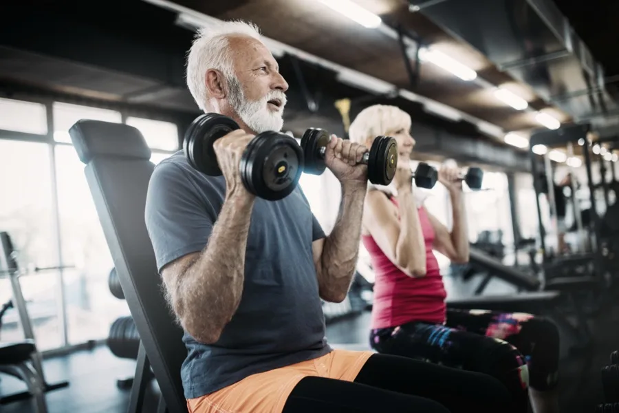 Members lifting free weights together at the gym